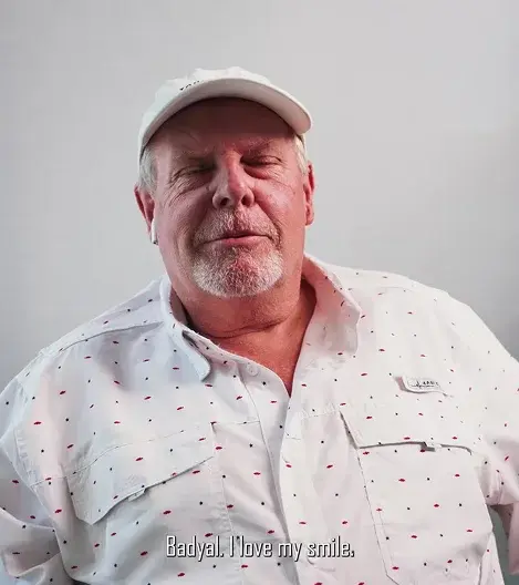 Smiling man wearing white cap and patterned shirt for dental practice testimonial.